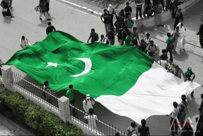 Pakistan-Flag-Lovers-Students-displaying-a-large-Pakistani-flag-on-Independence-Day-at-Karachi-University-Proud-Display-of-Pakistani-flag